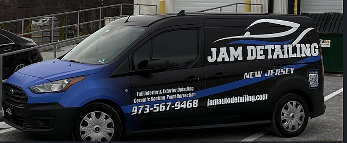 The JAM Detailing van, a blue and black wrapped Ford Transit Connect
